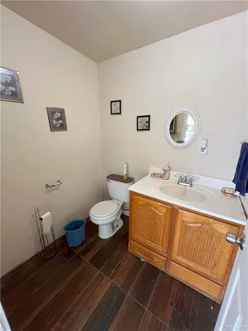 a spacious bathroom with a double vanity sink toilet and a mirror