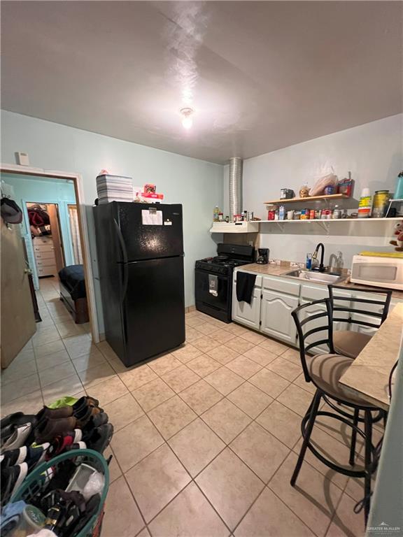 414 Mockingbird Lane Mercedes, TX 78570 - Photo 21 of 27 a kitchen with stainless steel appliances kitchen island granite countertop a refrigerator and a stove top oven