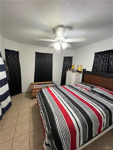 a bedroom with bed and balcony