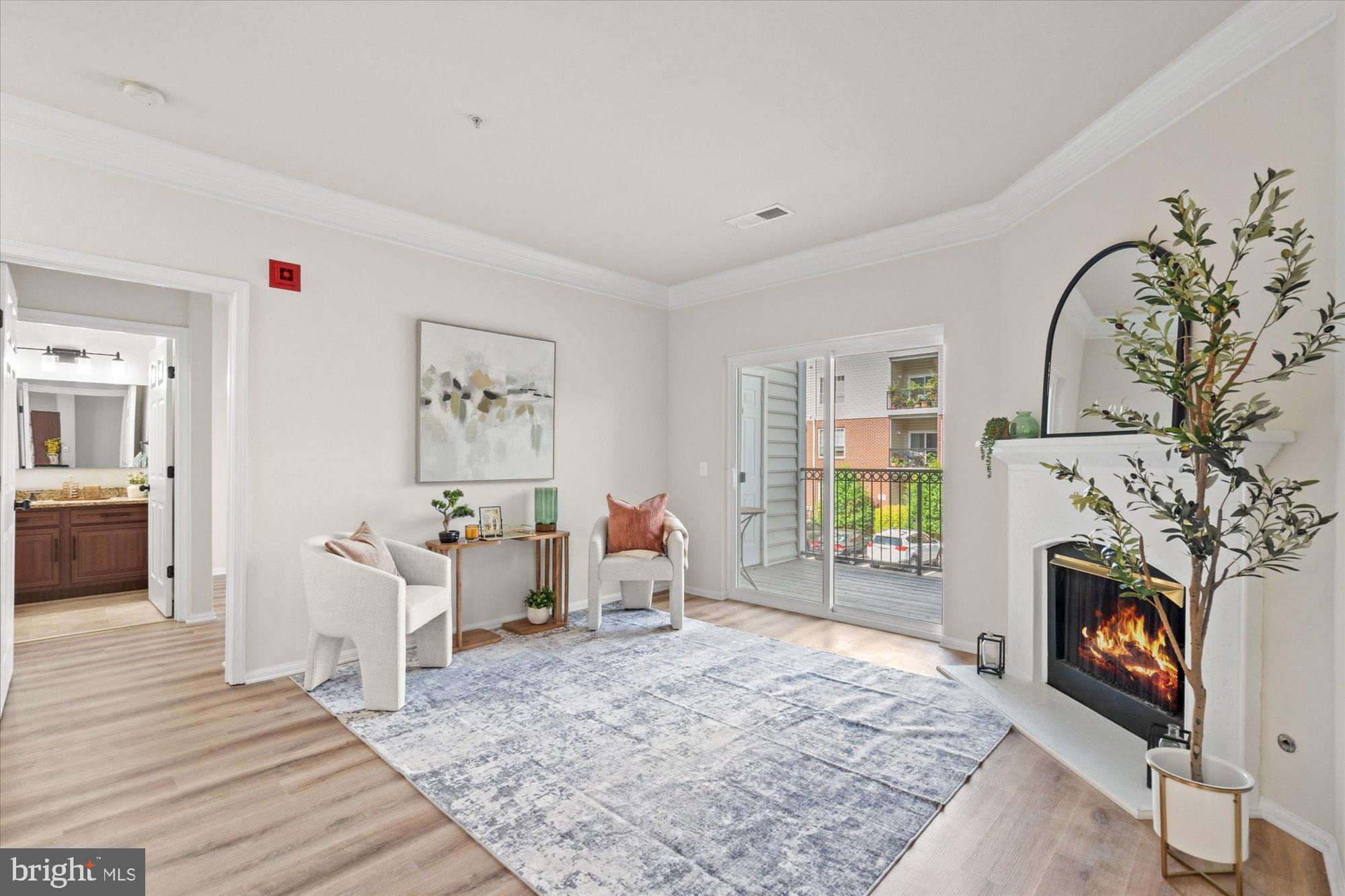 1571 Spring Gate Dr., Unit 6213 McLean, VA 22102 - Photo 1 of 39 a living room with furniture a fireplace and a flat screen tv