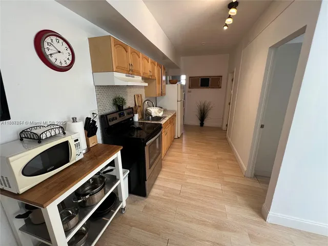 a view of a kitchen with a stove and a refrigerator