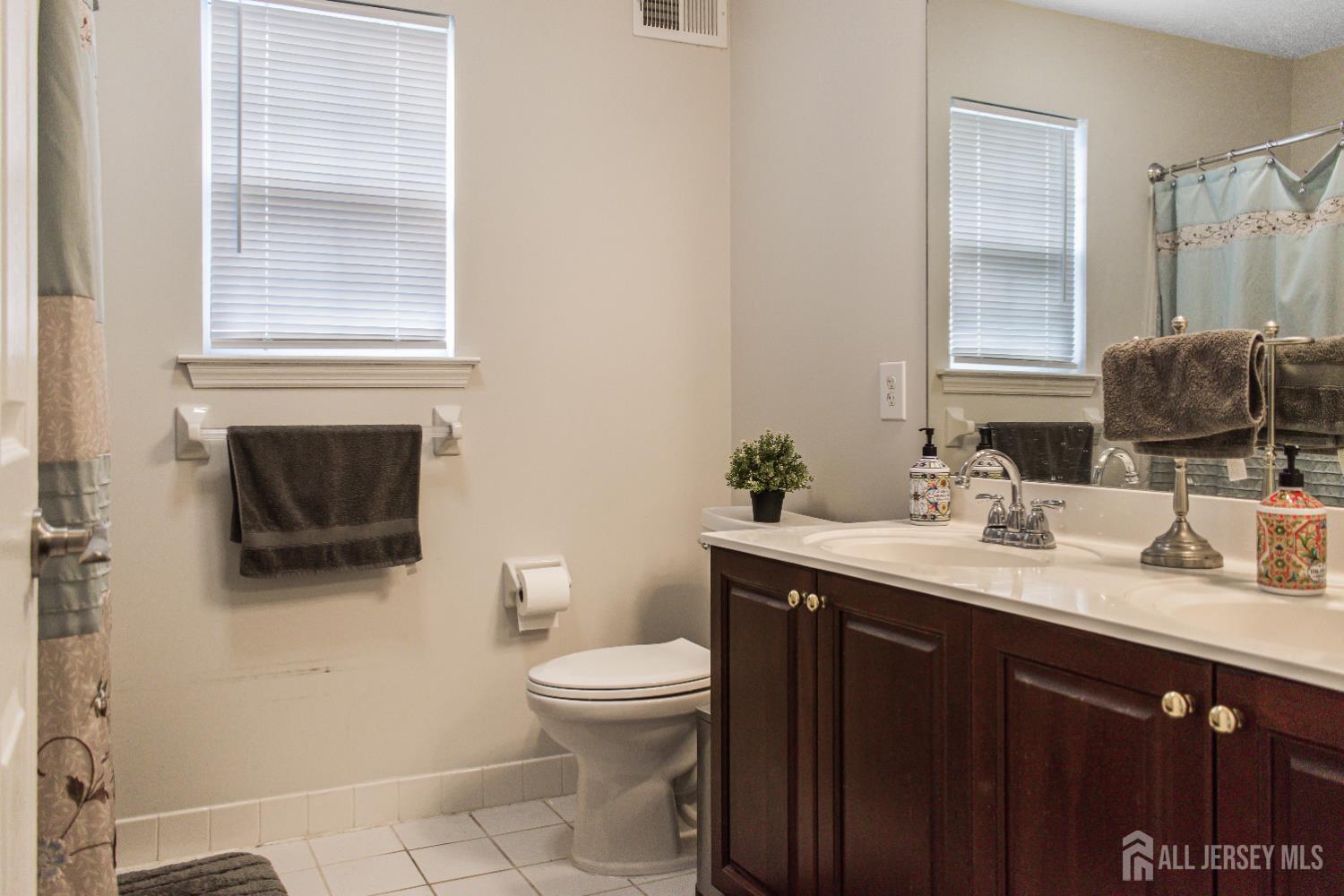 22 Ginger Drive Edison, NJ 08837 - Photo 23 of 41 a bathroom with a sink a toilet and mirror