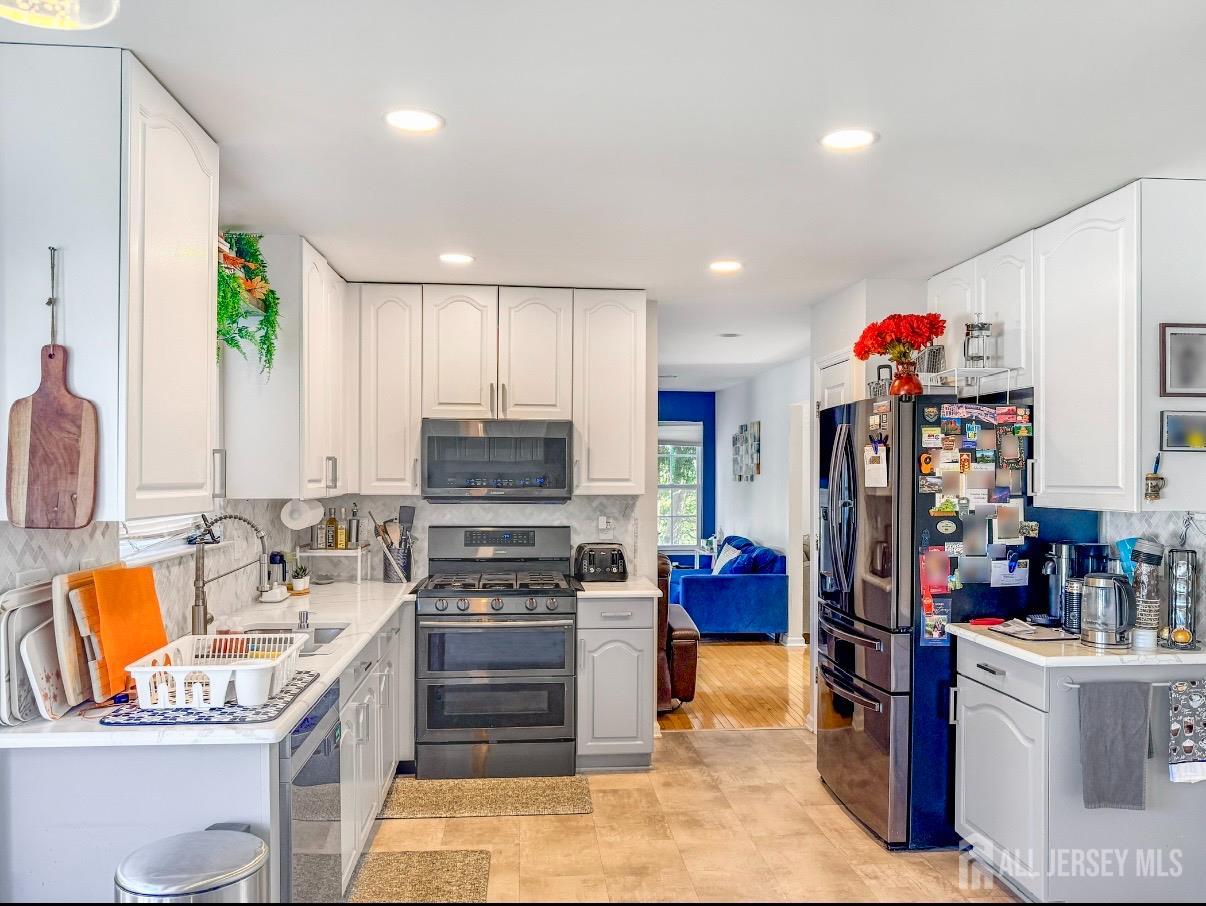 22 Ginger Drive Edison, NJ 08837 - Photo 4 of 41 a kitchen that has a sink counter top space appliances and cabinets
