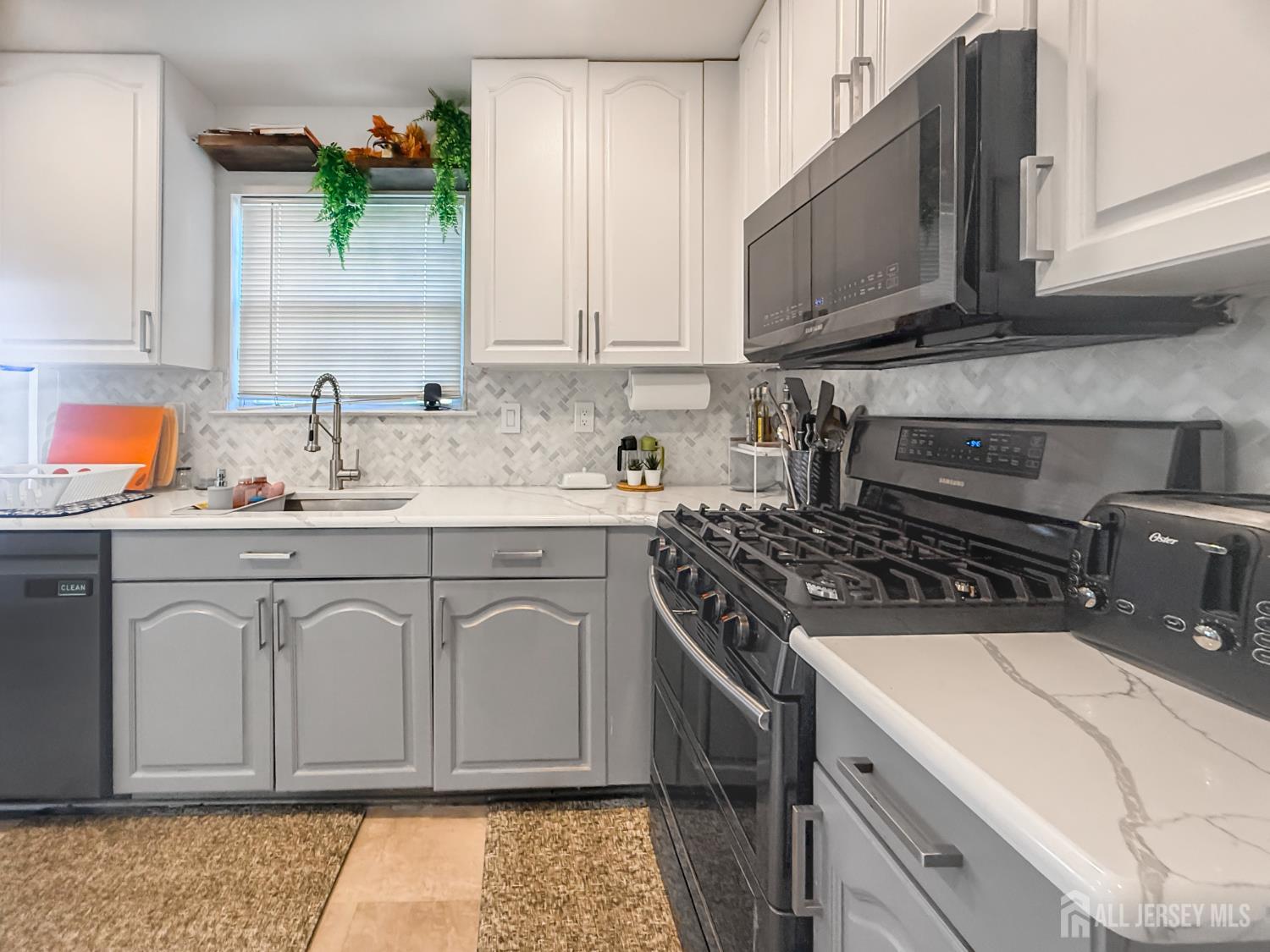 22 Ginger Drive Edison, NJ 08837 - Photo 5 of 41 a white kitchen with granite countertop a sink a stove and cabinets