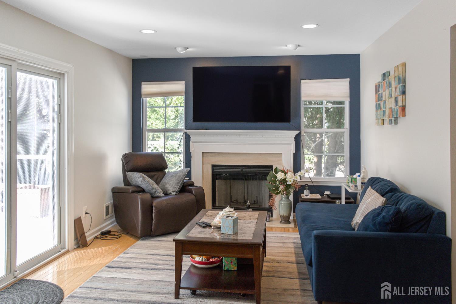 22 Ginger Drive Edison, NJ 08837 - Photo 10 of 41 a living room with furniture a flat screen tv and a fireplace
