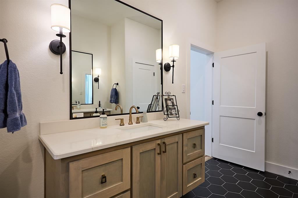 358 Glade Valley Road Azle, TX 76020 - Photo 13 of 35 Bathroom vanity featuring light wood cabinetry, a light-toned countertop, and a rectangular undermount sink