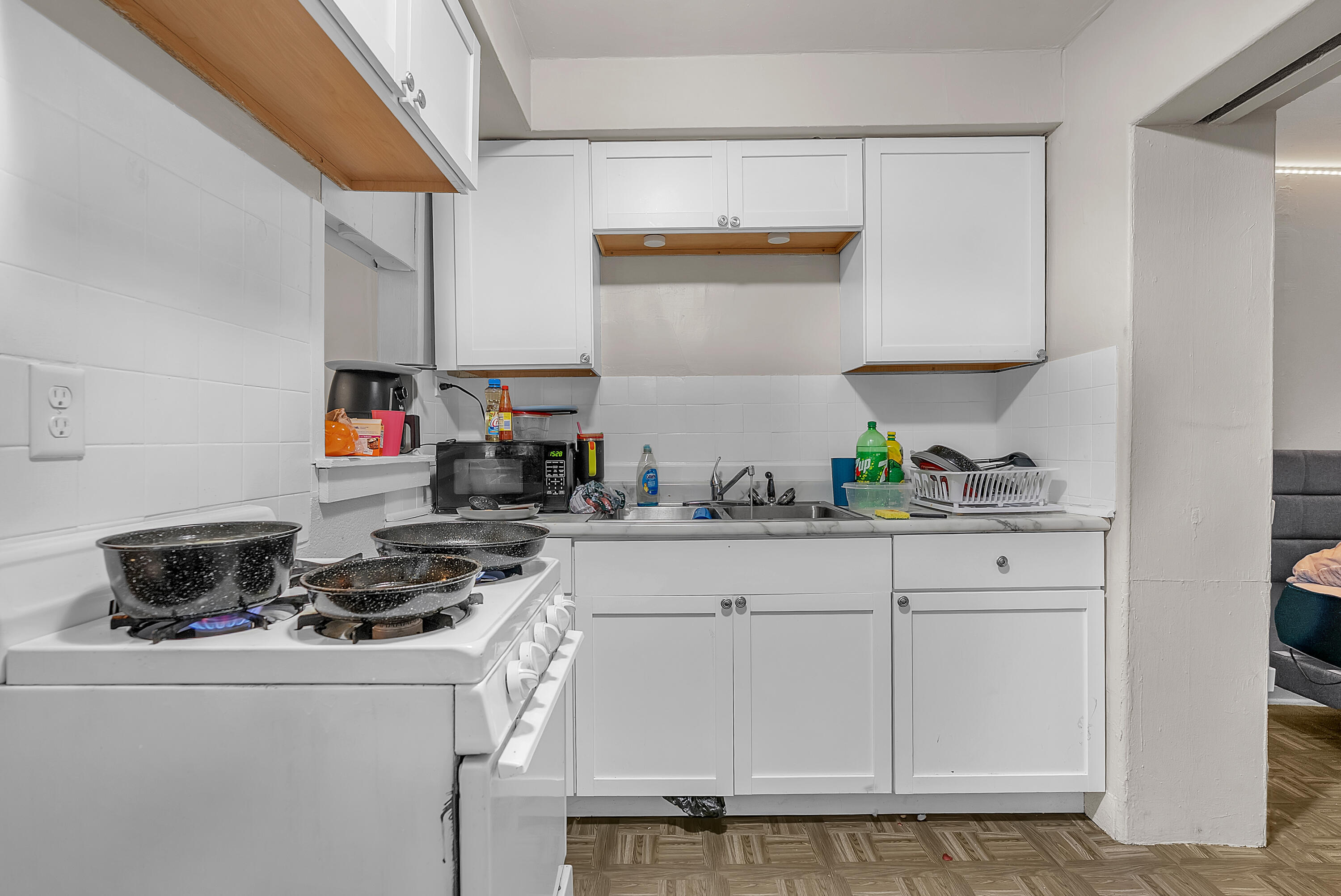 15 Rimbach Street Hammond, IN 46320 - Photo 13 of 31 a kitchen with white cabinets and appliances