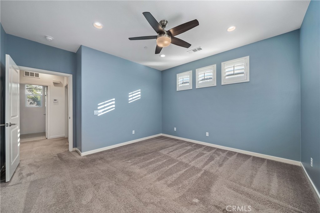 11082 Panoramic Drive Rancho Cucamonga, CA 91730 - Photo 16 of 48 an empty room with window and ceiling fan
