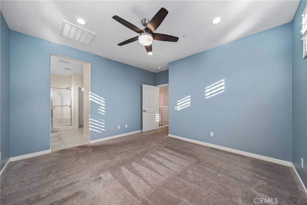 11082 Panoramic Drive Rancho Cucamonga, CA 91730 - Photo 17 of 48 a view of an empty room with a ceiling fan