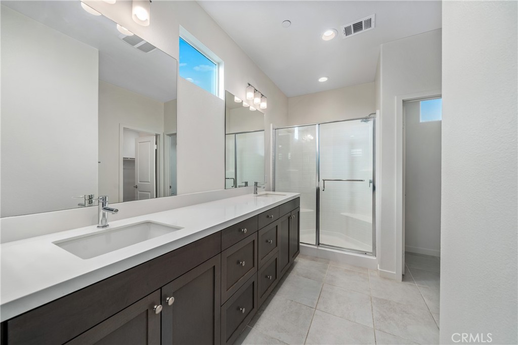 11082 Panoramic Drive Rancho Cucamonga, CA 91730 - Photo 18 of 48 a spacious bathroom with a double vanity sink mirror and double