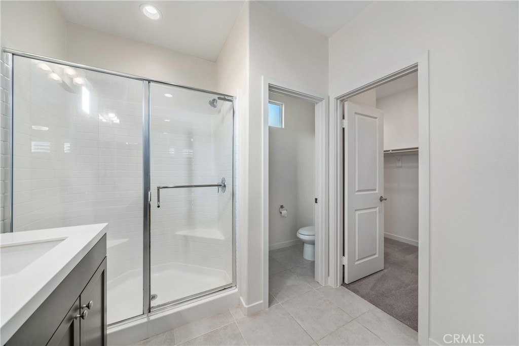11082 Panoramic Drive Rancho Cucamonga, CA 91730 - Photo 19 of 48 a bathroom with a shower and a sink