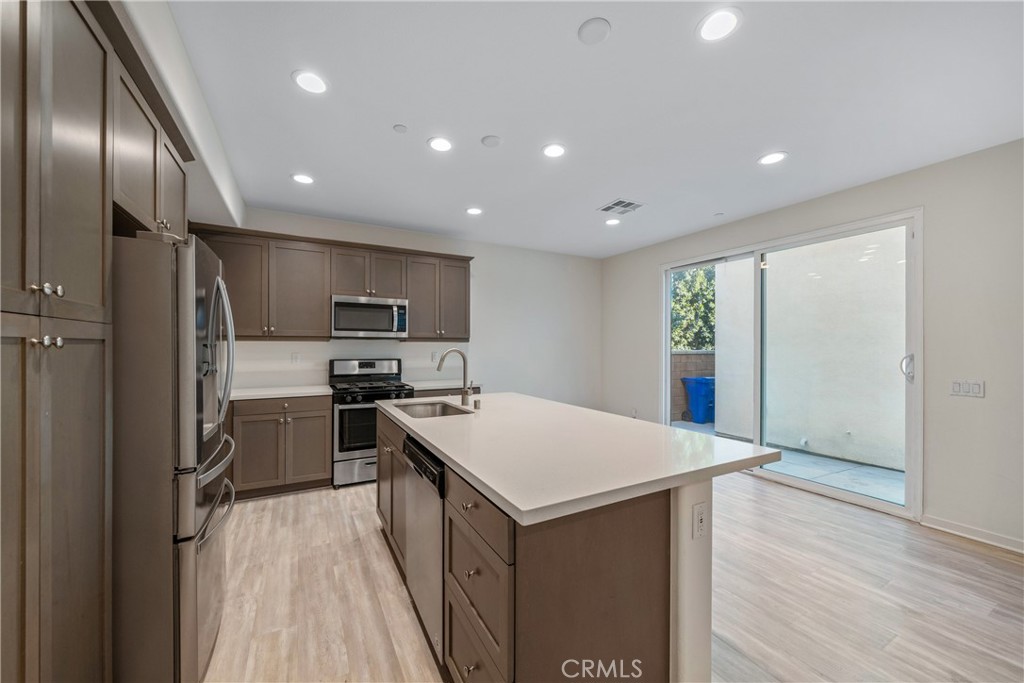 11082 Panoramic Drive Rancho Cucamonga, CA 91730 - Photo 4 of 48 a kitchen with a refrigerator a sink and a stove top oven