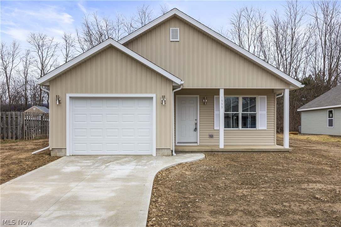 1999 East Oldgate Road Sandusky, OH 44870 - Photo 1 of 32 View of front of home with a garage, a porch, and concrete driveway