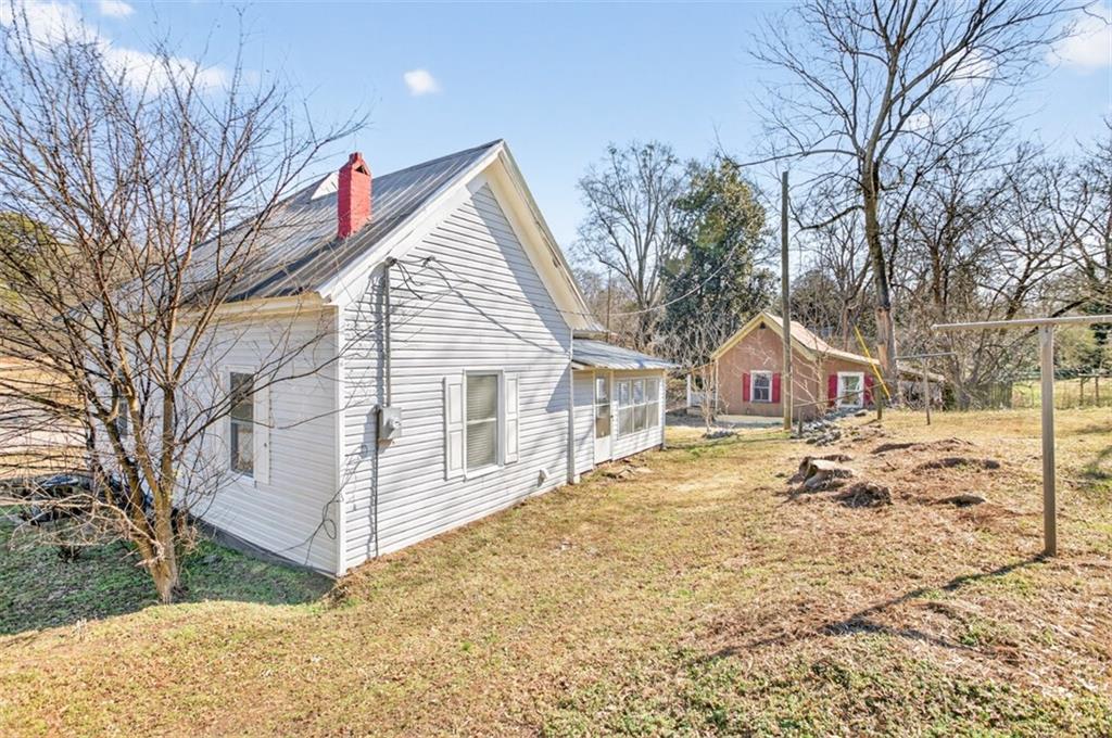 246 Spring Street Commerce, GA 30529 - Photo 21 of 23 a front view of a house with a yard covered in snow