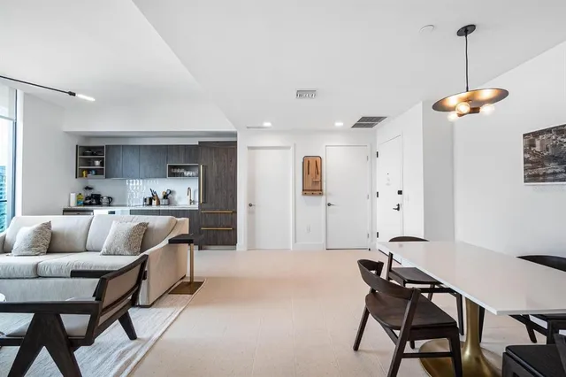 a living room with furniture and a chandelier