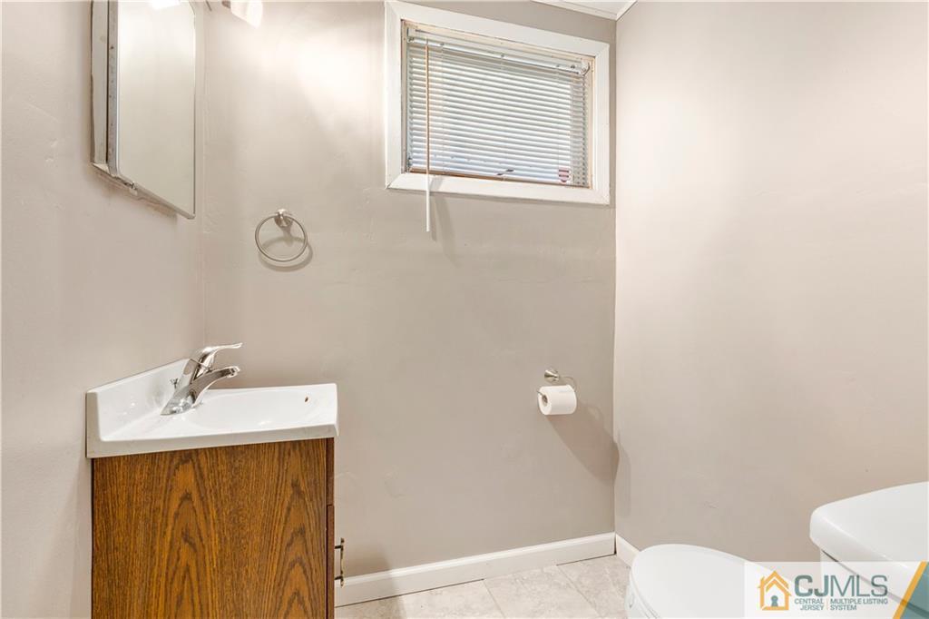 63 Daniel Street Carteret, NJ 07008 - Photo 14 of 20 a bathroom with a sink a toilet and shower