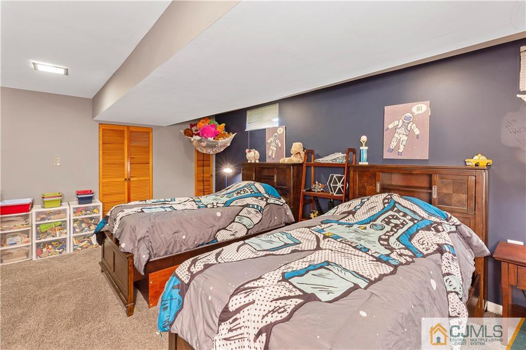 63 Daniel Street Carteret, NJ 07008 - Photo 15 of 20 a bedroom with bed and a table