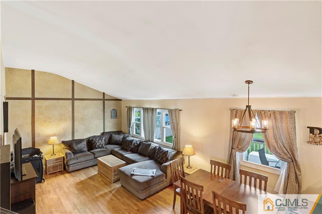 63 Daniel Street Carteret, NJ 07008 - Photo 7 of 20 a living room with furniture a lamp and a floor to ceiling window