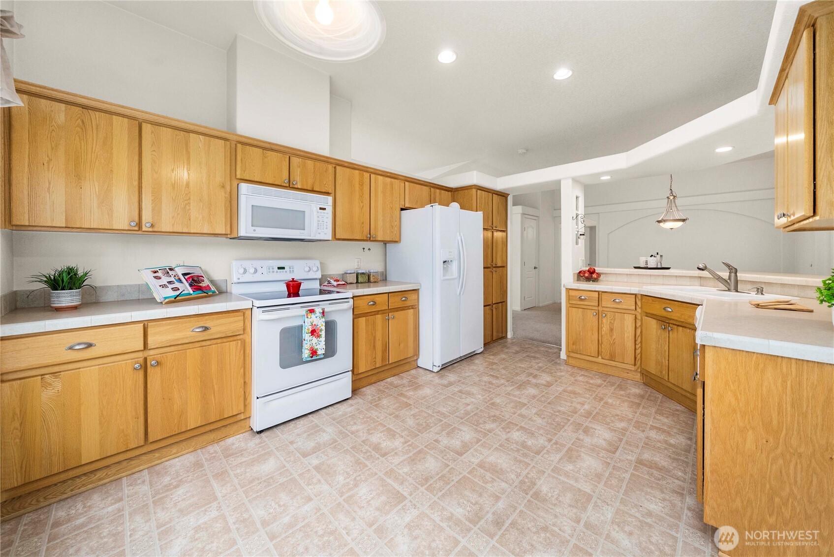 9806 196th Street East Graham, WA 98338 - Photo 11 of 31 a kitchen with white cabinets and white appliances