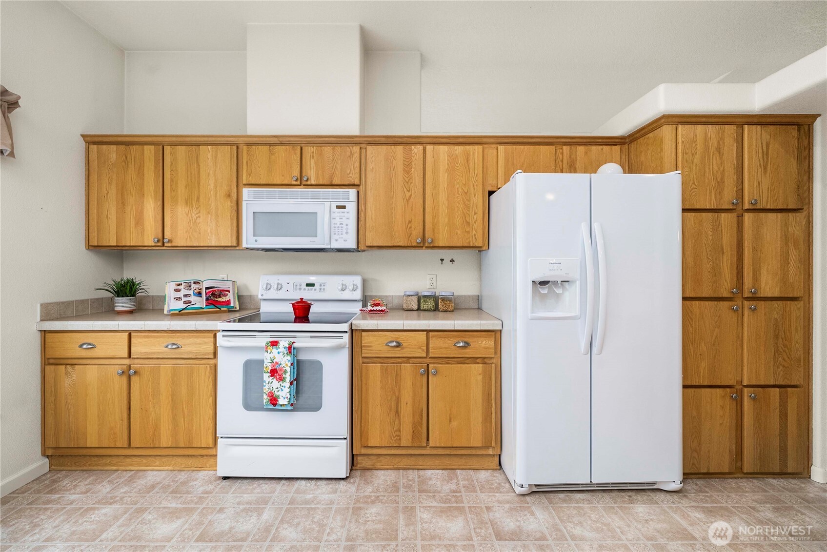 9806 196th Street East Graham, WA 98338 - Photo 12 of 31 a kitchen with stainless steel appliances granite countertop a refrigerator and a stove top oven