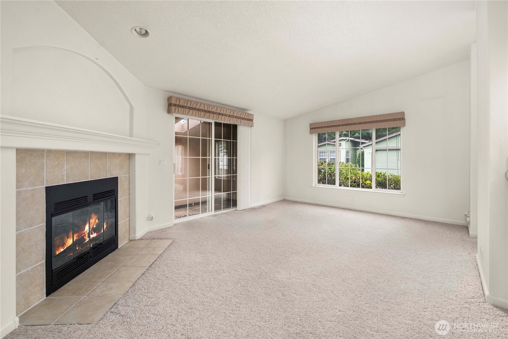 9806 196th Street East Graham, WA 98338 - Photo 16 of 31 a view of an empty room with a window and fireplace