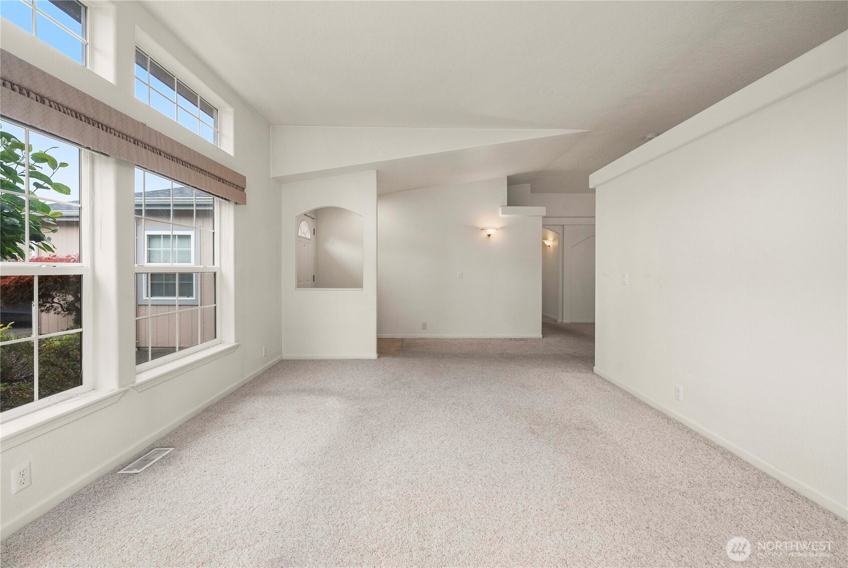 9806 196th Street East Graham, WA 98338 - Photo 5 of 31 an empty room with windows and pillars in it