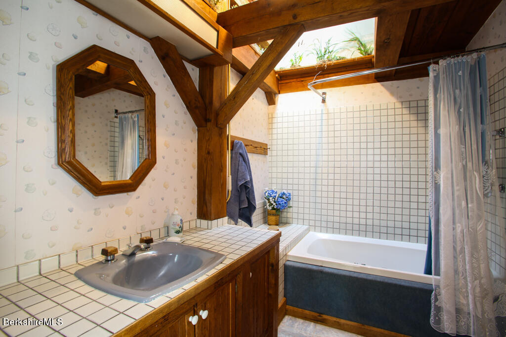 544 Tunnel Road Rowe, MA 01367 - Photo 23 of 32 a bathroom with a sink vanity tub and a mirror