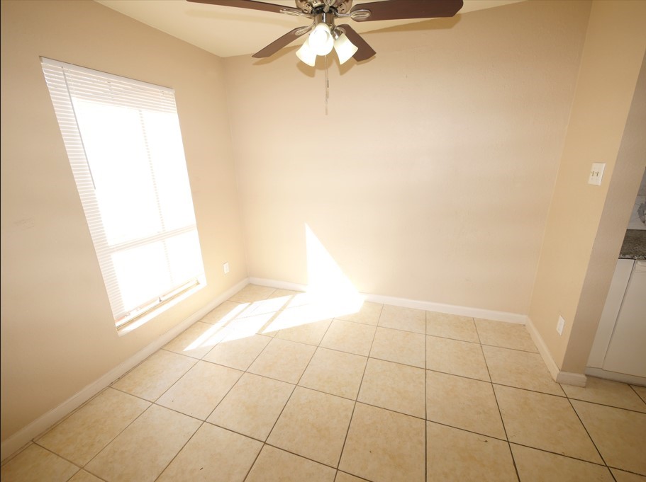 10100 South Gessner Road, Unit 202 Houston, TX 77071 - Photo 4 of 9 a view of an empty room and chandelier fan