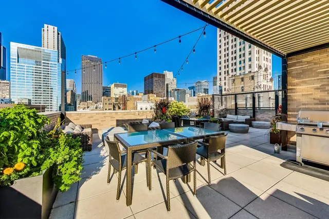 a view of a patio with a table and chairs and potted plants