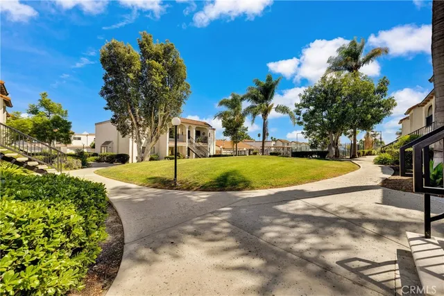 a view of a house with a garden and outdoor seating
