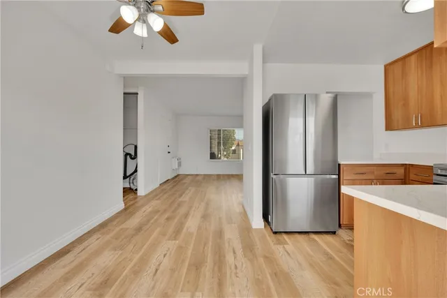 a view of kitchen with a refrigerator cabinets and wooden floor