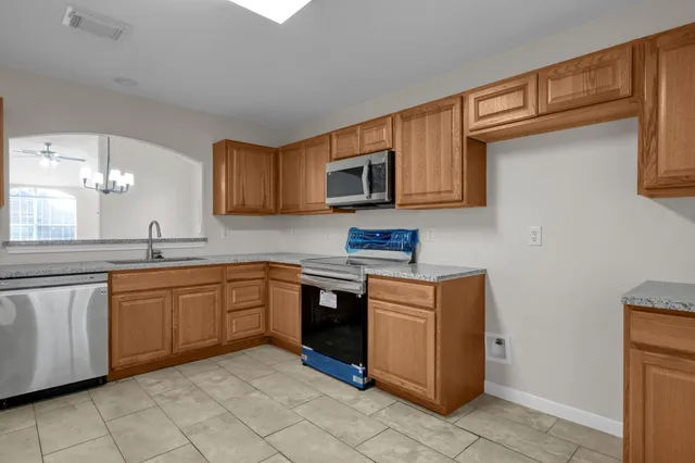 a kitchen with stainless steel appliances granite countertop a sink and cabinets