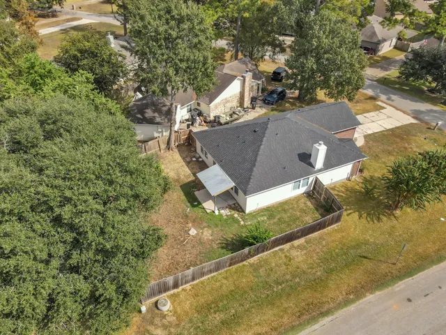 an aerial view of a house with yard