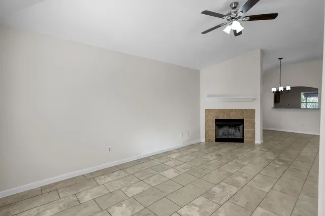 a view of an empty room with a fireplace