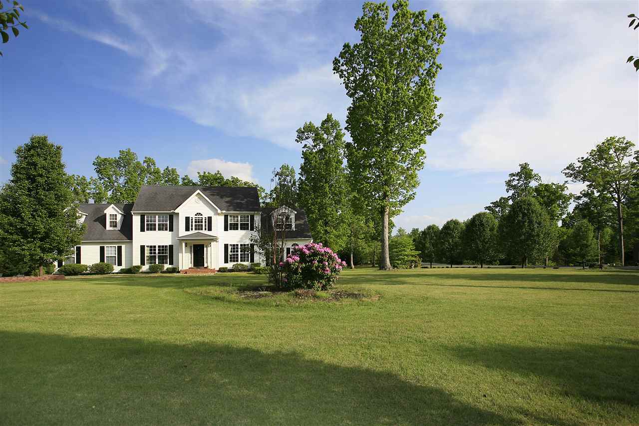 153 Deerview Road Keswick, VA 22947 - Photo 12 of 31 a front view of a house with a garden and trees