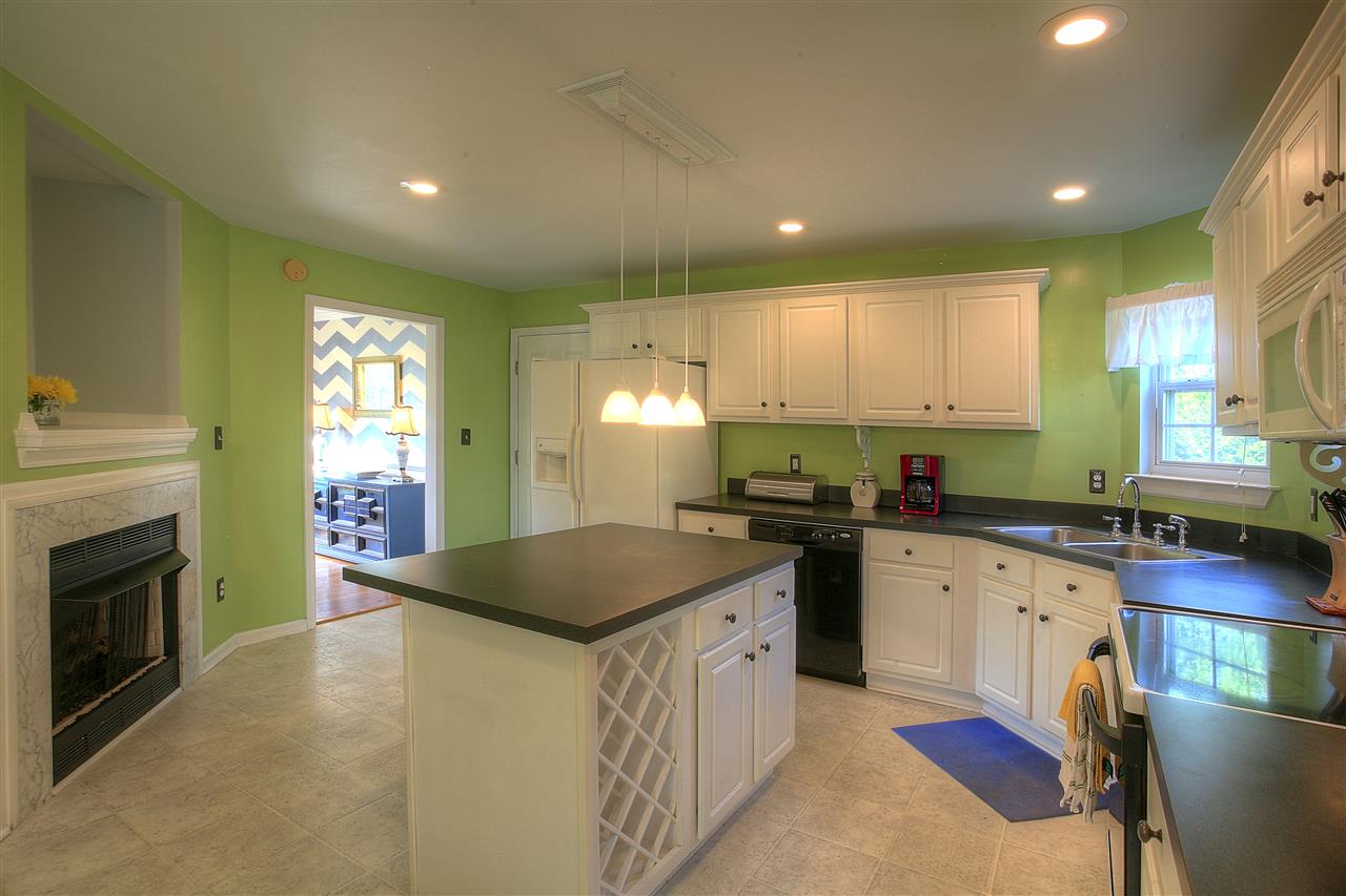 153 Deerview Road Keswick, VA 22947 - Photo 20 of 31 a kitchen with granite countertop a sink stove and cabinets