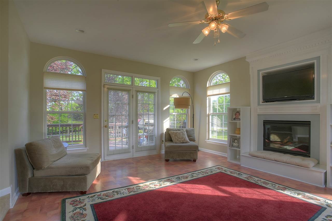153 Deerview Road Keswick, VA 22947 - Photo 21 of 31 a living room with furniture a flat screen tv and a fireplace