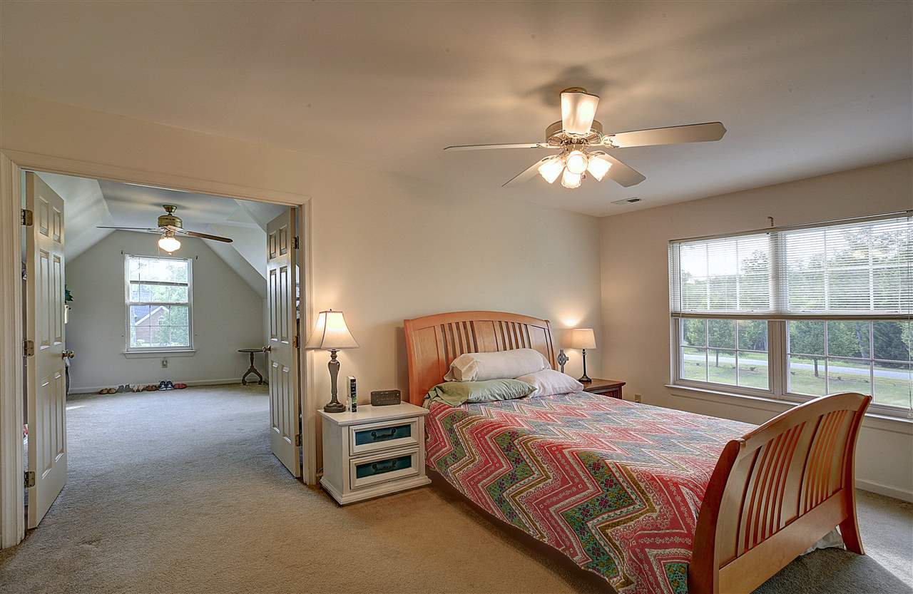 153 Deerview Road Keswick, VA 22947 - Photo 24 of 31 a bedroom with a bed and a chandelier