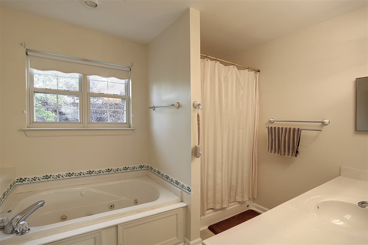 153 Deerview Road Keswick, VA 22947 - Photo 26 of 31 a bathroom with a bathtub and a window