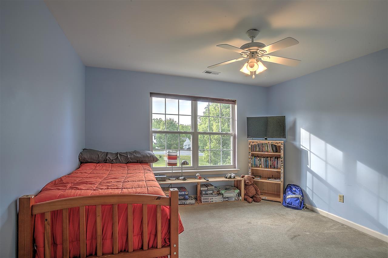 153 Deerview Road Keswick, VA 22947 - Photo 28 of 31 a bedroom with a bed and a chandelier