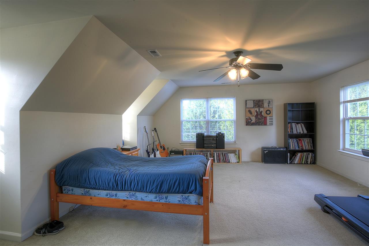153 Deerview Road Keswick, VA 22947 - Photo 30 of 31 a bedroom with furniture and a chandelier