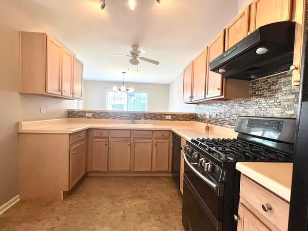 a kitchen with stainless steel appliances granite countertop a stove a sink dishwasher and a refrigerator