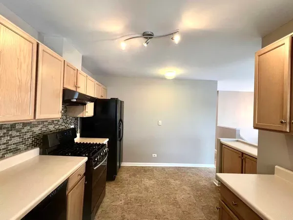 a kitchen with cabinets and appliances