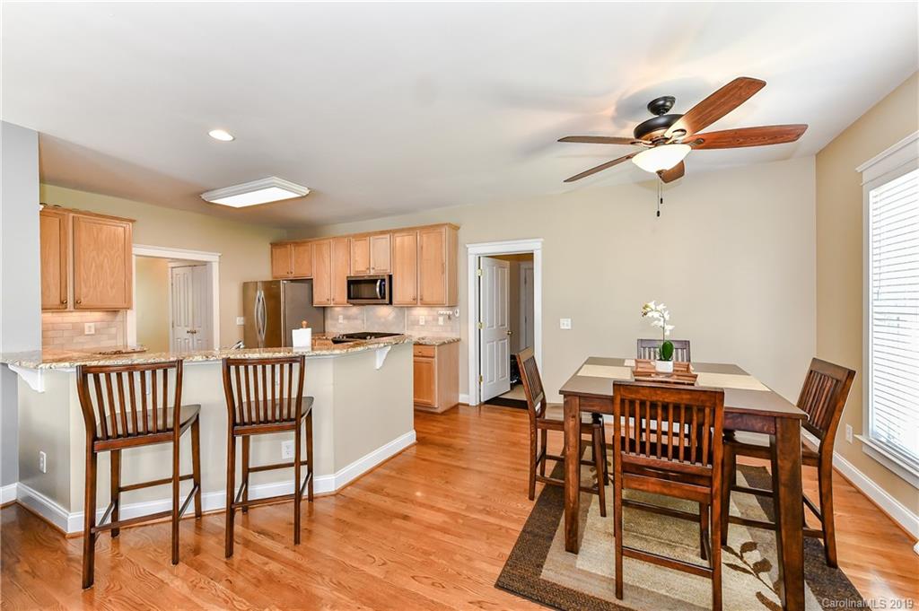 1036 Hunters Run Drive Tega Cay, SC 29708 - Photo 11 of 35 a view of a dining room with furniture window and wooden floor
