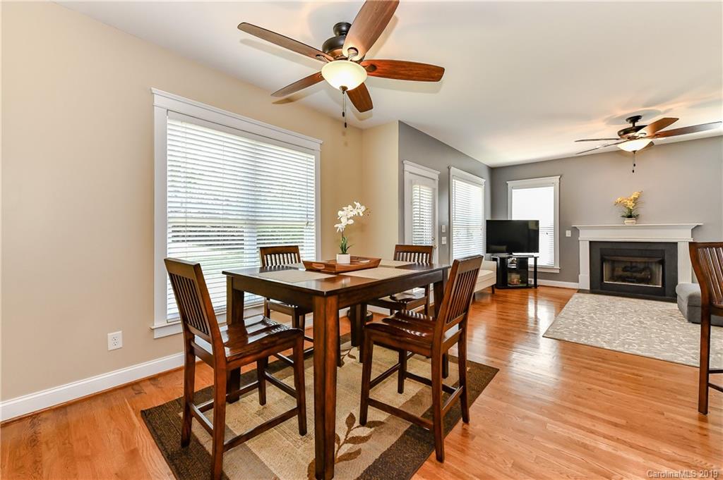 1036 Hunters Run Drive Tega Cay, SC 29708 - Photo 15 of 35 a view of a dining room with furniture window and wooden floor