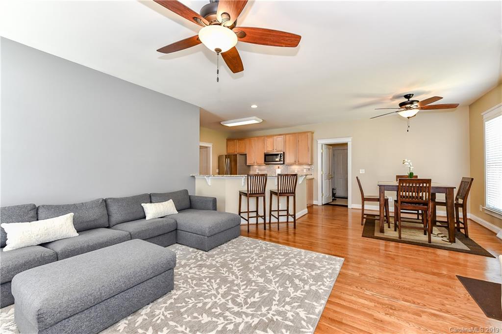1036 Hunters Run Drive Tega Cay, SC 29708 - Photo 20 of 35 a living room with furniture wooden floor and a ceiling fan