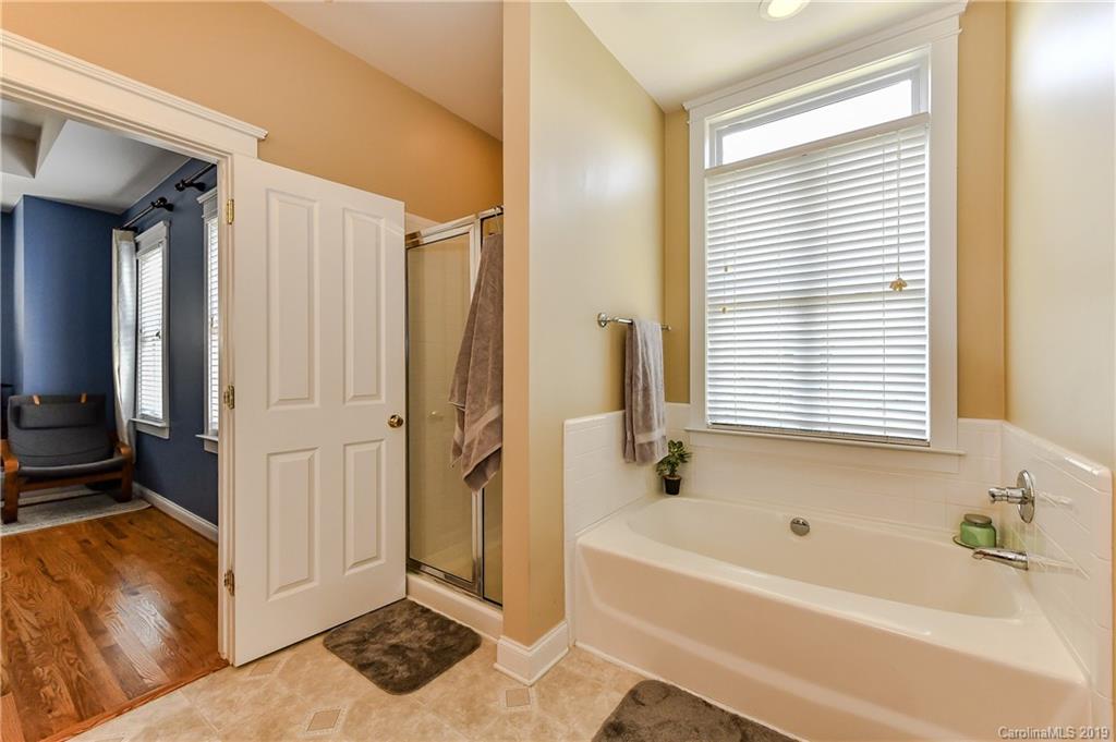 1036 Hunters Run Drive Tega Cay, SC 29708 - Photo 23 of 35 a bathroom with a bathtub and a shower