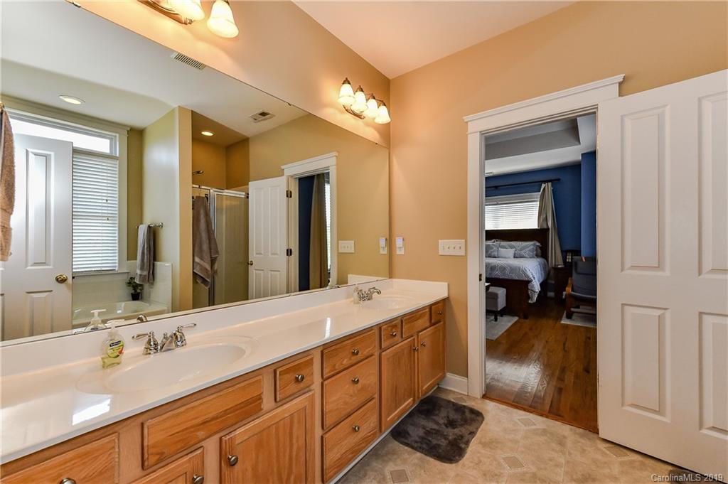 1036 Hunters Run Drive Tega Cay, SC 29708 - Photo 24 of 35 a spacious bathroom with a double vanity sink and a mirror