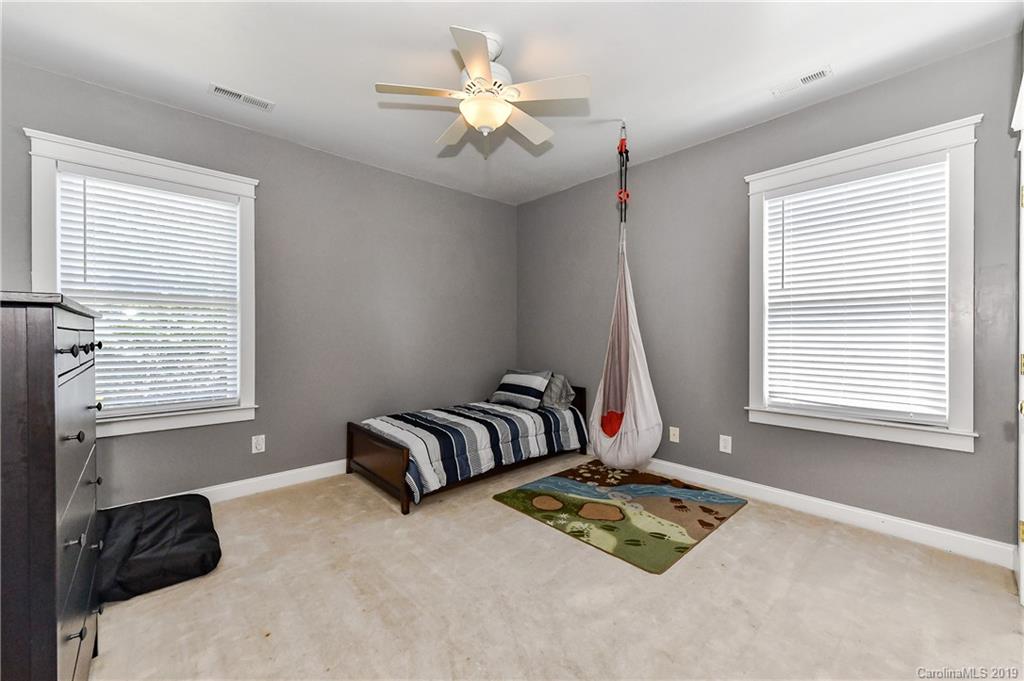 1036 Hunters Run Drive Tega Cay, SC 29708 - Photo 25 of 35 a bedroom with furniture and a window