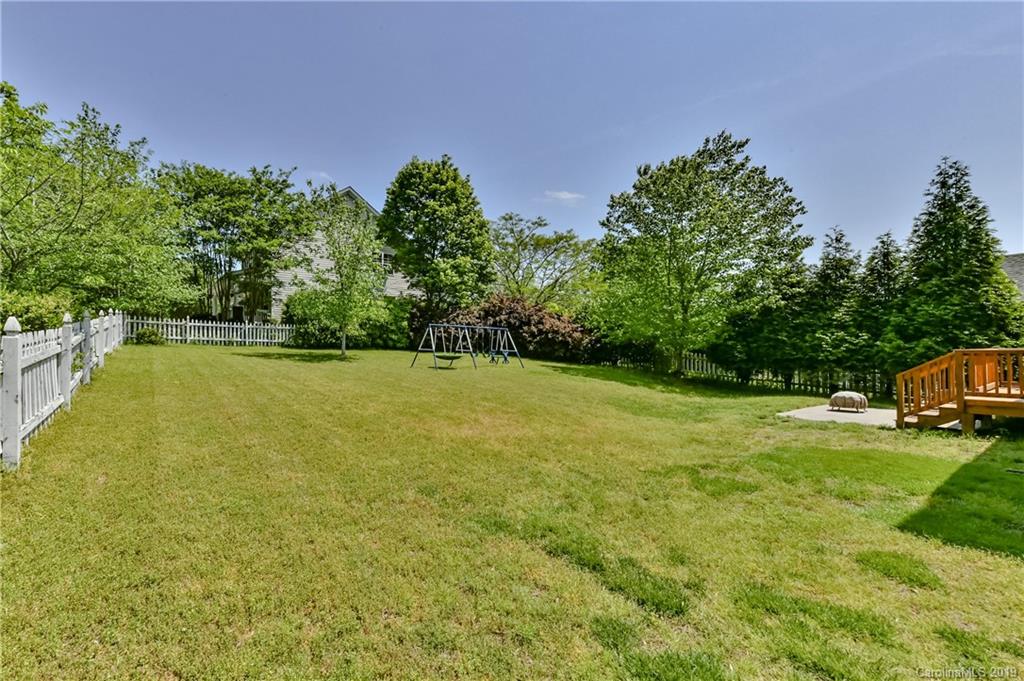 1036 Hunters Run Drive Tega Cay, SC 29708 - Photo 32 of 35 a view of a field with lawn chairs and wooden fence